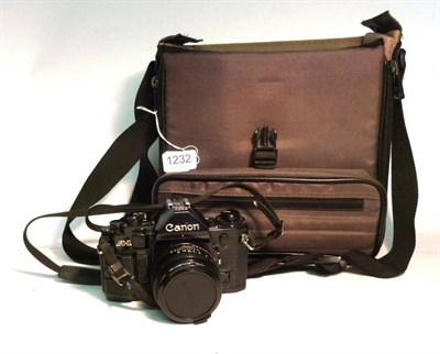 Lot 1232 - A Canon A1 Camera Outfit, serial number 969262, black camera body, with f1.8/50mm lens,...