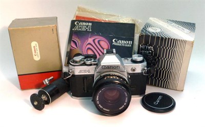 Lot 1237 - A Canon AE-1 Camera No.81307, in chrome, with FD f1.8/50mm lens, accessories and manual