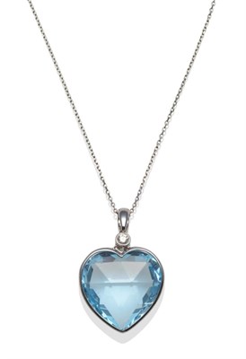 Lot 311 - A Blue Topaz and Diamond Pendant, the heart shaped faceted blue topaz in a white collet...