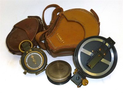 Lot 1011 - Three Compasses, comprising a Stanley prismatic surveying compass, in stitched leather case,...