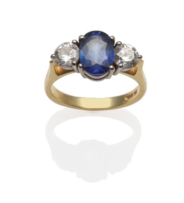 Lot 318 - An 18 Carat Gold Sapphire and Diamond Three Stone Ring, the oval cut sapphire between two round...