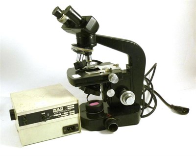 Lot 1033 - A Black Enamelled Binocular Compound Model M20 Microscope by Wild, Switzerland, with four...