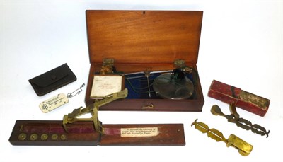 Lot 1062 - Five Sets of Scales, comprising a folding brass guinea scale with weights in a mahogany case, a...