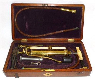 Lot 1064 - A 19th Century Lacquered Brass Enema Set by Aitken York, the brass pump with ivory handle, with two
