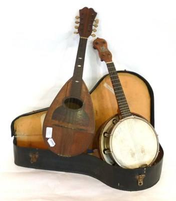 Lot 1165 - A George Formby Four String Banjolele, numbered 2786, with wooden resonator, black plastic...