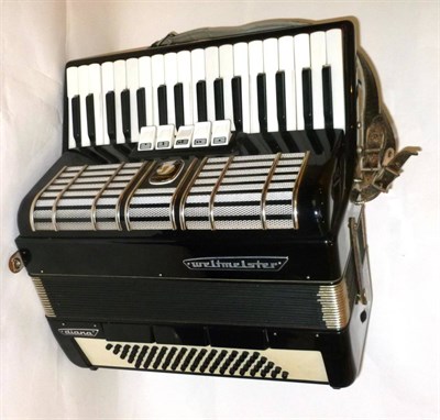 Lot 1174 - A Weltmeister 'Diana' Piano Accordion, with black and white plastic covered body, in a carrying...