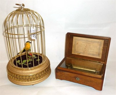 Lot 1192 - A Mechanical Singing Bird in a Gilded Cage Automaton, the single bird with yellow and black plumage