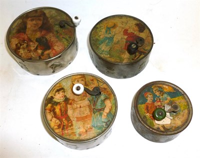 Lot 1202 - Four Manivelle Music Boxes, each with cylindrical metal bodies, lithographed pictorial paper...