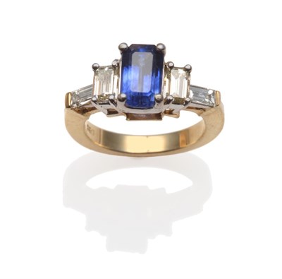 Lot 352 - ~ A Sapphire and Diamond Ring, an emerald-cut sapphire between two baguette cut diamonds, in...