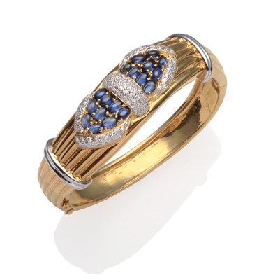 Lot 353 - ~ A Sapphire and Diamond Bangle, oval cabochon sapphires and round brilliant cut diamonds pavé set