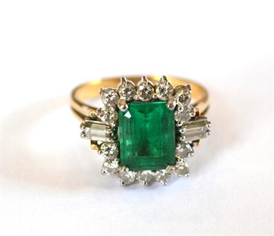 Lot 359 - An Emerald and Diamond Cluster Ring, the emerald-cut emerald within a border of round brilliant cut