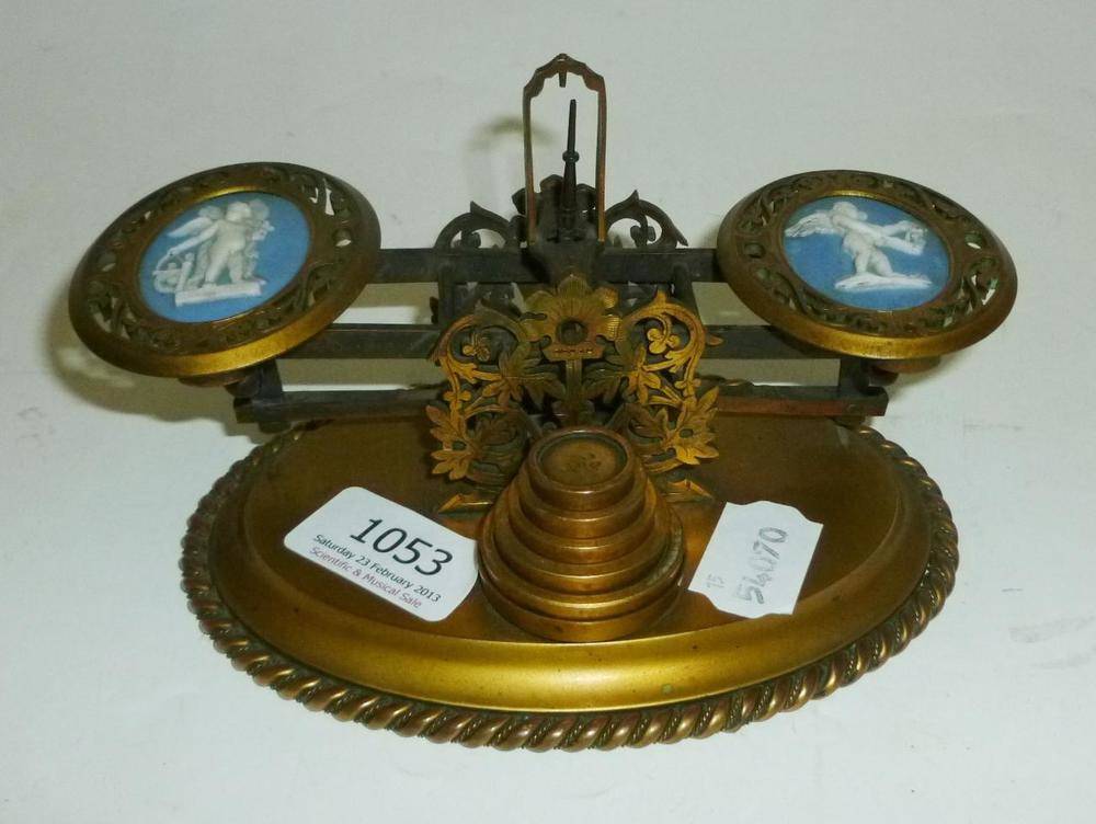 Lot 1053 - An Ornate 19th Century Brass Postal Scale, the pierced brass pans inset with Wedgwood plaques,...