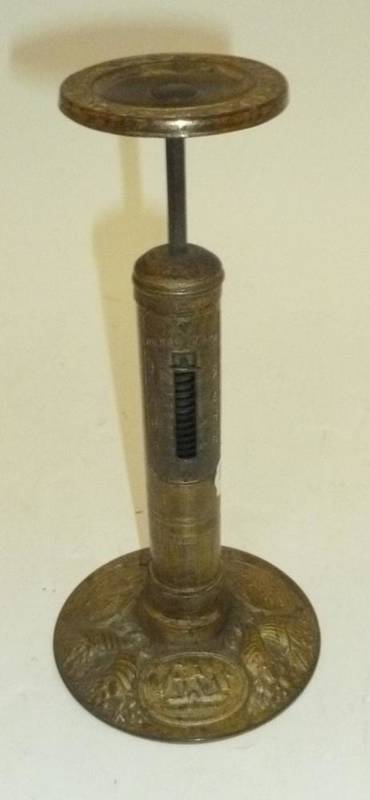 Lot 1054 - A 19th Century Brass Candlestick Letter Scale, the base embossed with a locomotive, a ship and...