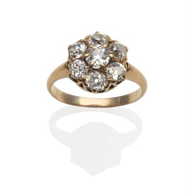 Lot 366 - A Diamond Cluster Ring, seven old cut diamonds in yellow claw settings, to a plain polished...