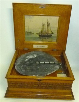 Lot 1151 - An Oak Cased Table Top 'Olympia' Musical Disc Player, serial number 2148, with 16.5cm steel...