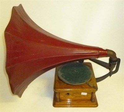 Lot 1171 - An Oak Cased Horn Gramophone, with cast iron support arm, alloy soundbox, and large pressed tin...