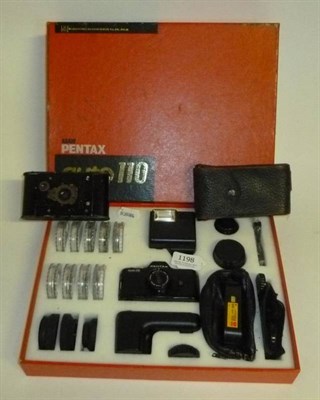 Lot 1198 - A Boxed Pentax Auto 110 SLR Camera Outfit, containing camera, lenses, flash, filters, case etc,...