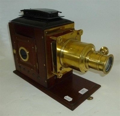 Lot 1225 - A 19th Century Mahogany and Brass Magic Lantern, with tinplate hood, hinged side panel with...