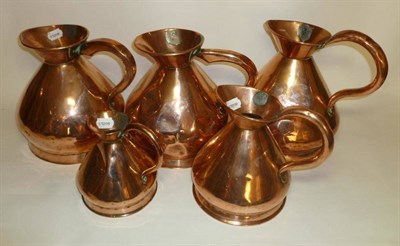 Lot 1046 - A Set of Five Victorian Copper Measuring Jugs, all stamped 'VR', comprising three one gallon,...