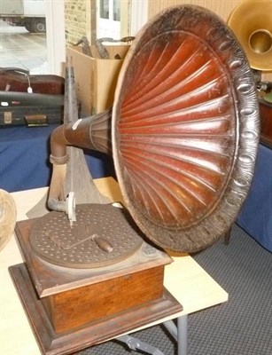 Lot 1176 - An Oak Cased Horn Gramophone, with pierced turntable, mica inset sound box, ornate cast iron...