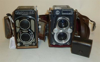 Lot 1232 - Two Yashica 44 TLR Cameras:- Yashica 44A, serial number 3991605, in black enamel and grey, stitched