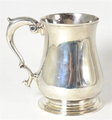 Lot 411 - A George II Silver Mug, maker's mark not clear, London 1747, of typical baluster form with a scroll