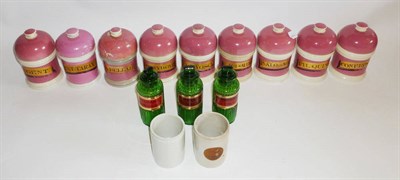 Lot 1051 - A Set of Nine 19th Century Pink Pottery Drug Jars, with gilt labels and domed lids, height...