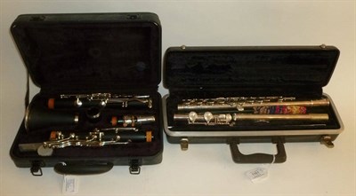 Lot 1161 - A Plastic Clarinet by J Michael, in a hard plastic case; A Selmer Bundy Silver Plated Flute, serial