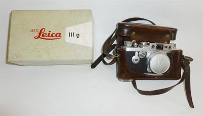 Lot 1218 - A Leica IIIg Camera No.933589, in chrome, with screw mount Elmar 50mm f/2.8 lens Nr.1620089,...