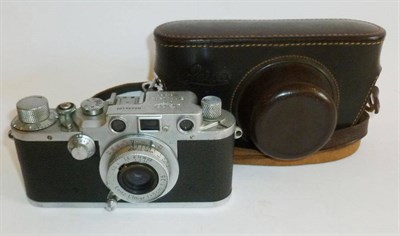 Lot 1221 - A Leica IIIc Camera No.434107, in chrome, with Elmar 50mm f/3.5 lens, in a stitched leather case