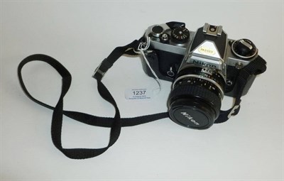 Lot 1237 - A Nikon FE Camera No.3020726, in chrome, with Nikkor 28mm f/3.5 lens No.1928723, in a leather case