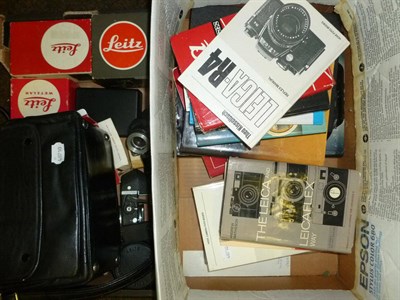 Lot 1240 - A Collection of Leica Accessories and Manuals, including a boxed tripod No.14100, extension...