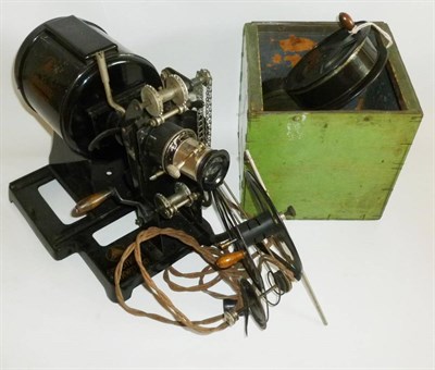 Lot 1260 - An Ernemann 'Kinoptikon' Black Enamelled Tinplate Hand Cranked Projector, together with rolls...