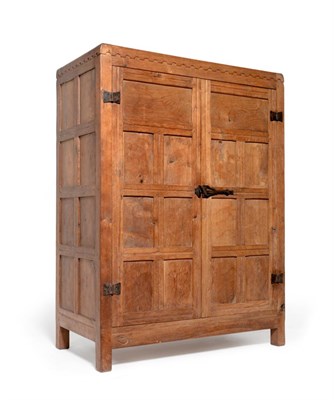 Lot 511 - A 1930s Robert  "Mouseman " Thompson Panelled Oak Wardrobe, with penny moulded top, above two doors