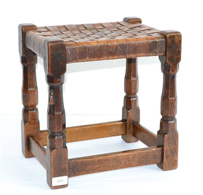 Lot 513 - A 1930s/40s Robert  "Mouseman " Thompson Oak Stool, with lattice leather top, on four octagonal...