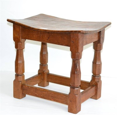 Lot 514 - A 1940s Robert  "Mouseman " Thompson Burr Oak Dish Top Stool, the adzed top on four octagonal...