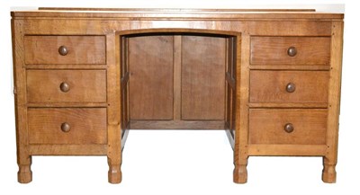 Lot 525 - A Robert  "Mouseman " Thompson Panelled Oak Kneehole Desk, with raised upstand, over a central...