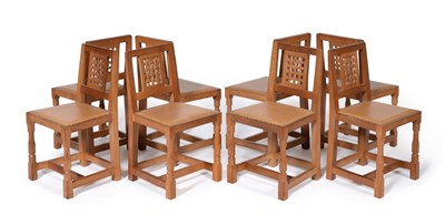 Lot 538 - A Set of Eight Robert  "Mouseman " Thompson Oak Lattice Back Dining Chairs, with cow hide...