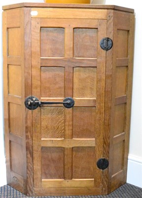 Lot 541 - A Robert  "Mouseman " Thompson Panelled Oak Hanging Corner Cupboard, the single door opening to...