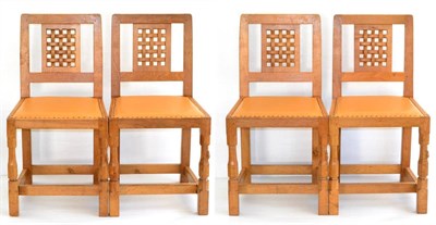 Lot 545 - A Set of Four Robert  "Mouseman " Thompson Oak Lattice Back Dining Chairs, with cow hide...