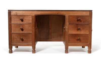 Lot 555 - A Robert  "Mouseman " Thompson Panelled Oak Kneehole Desk, with raised upstand, over a central...