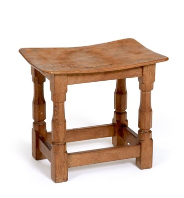 Lot 566 - A Robert  "Mouseman " Thompson Oak Dish Top Stool, on four octagonal legs joined by stretchers,...