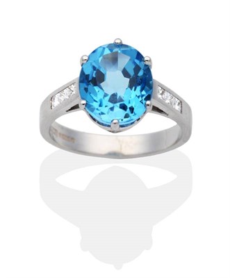 Lot 2004 - An 18 Carat White Gold Blue Topaz and Diamond Ring, an oval cut blue topaz in a claw setting,...