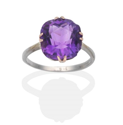 Lot 2005 - An Amethyst Ring, a cushion cut amethyst in a double claw setting, to knife edge shoulders,...