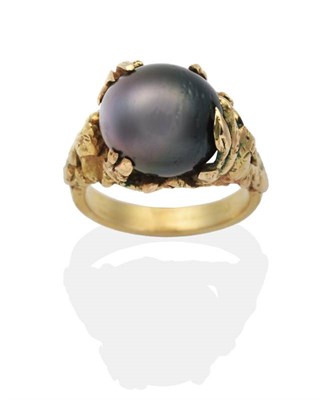 Lot 2034 - An 18 Carat Gold Cultured Tahitian Pearl Ring, an egg-shaped Tahitian pearl in an abstract claw...