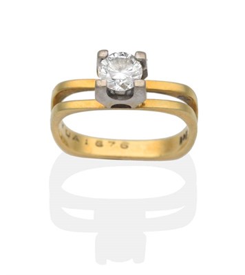 Lot 2040 - A Solitaire Diamond Ring, a round brilliant cut diamond in a claw setting, to a two bar square...