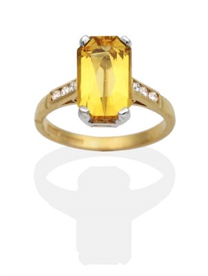 Lot 2044 - An 18 Carat Gold Yellow Beryl and Diamond Ring, an octagonal cut yellow beryl in a claw setting, to