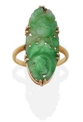Lot 2051 - A Jade Ring, a carved and pierced oval plaque depicting flowers and leaves, in a double claw...