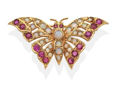Lot 2069 - A 9 Carat Gold Opal and Ruby Butterfly Brooch, set throughout with round cabochon opals and...