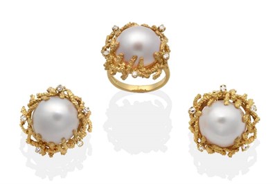 Lot 2071 - An 18 Carat Gold Mabe Pearl and Diamond Ring and Earring Suite, a mabe pearl within a textured...